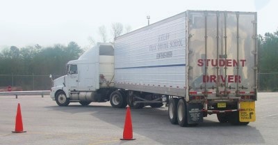 Katlaw student driver semi truck on training yard with cones